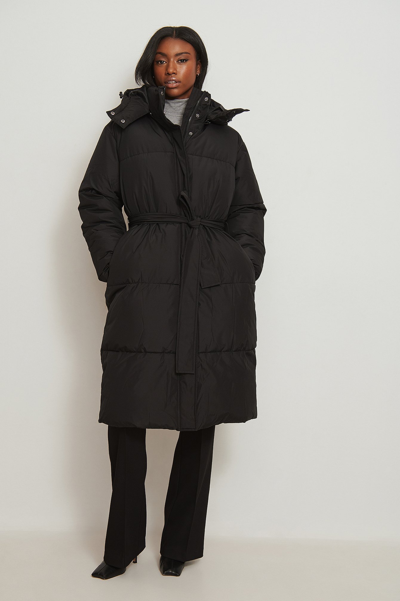 Belted black puffer top coat